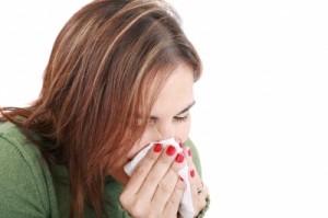 Woman with cold blowing nose