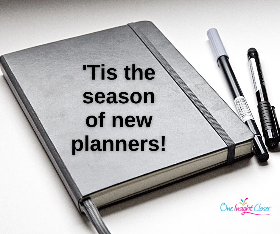 Picture of planner/journal with text over it "'Tis the season of new planners"