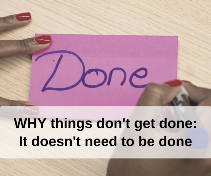 Background of a hands writing DONE on a pink sticky note with text on top "WHY things don't get done: It doesn't need to be done"